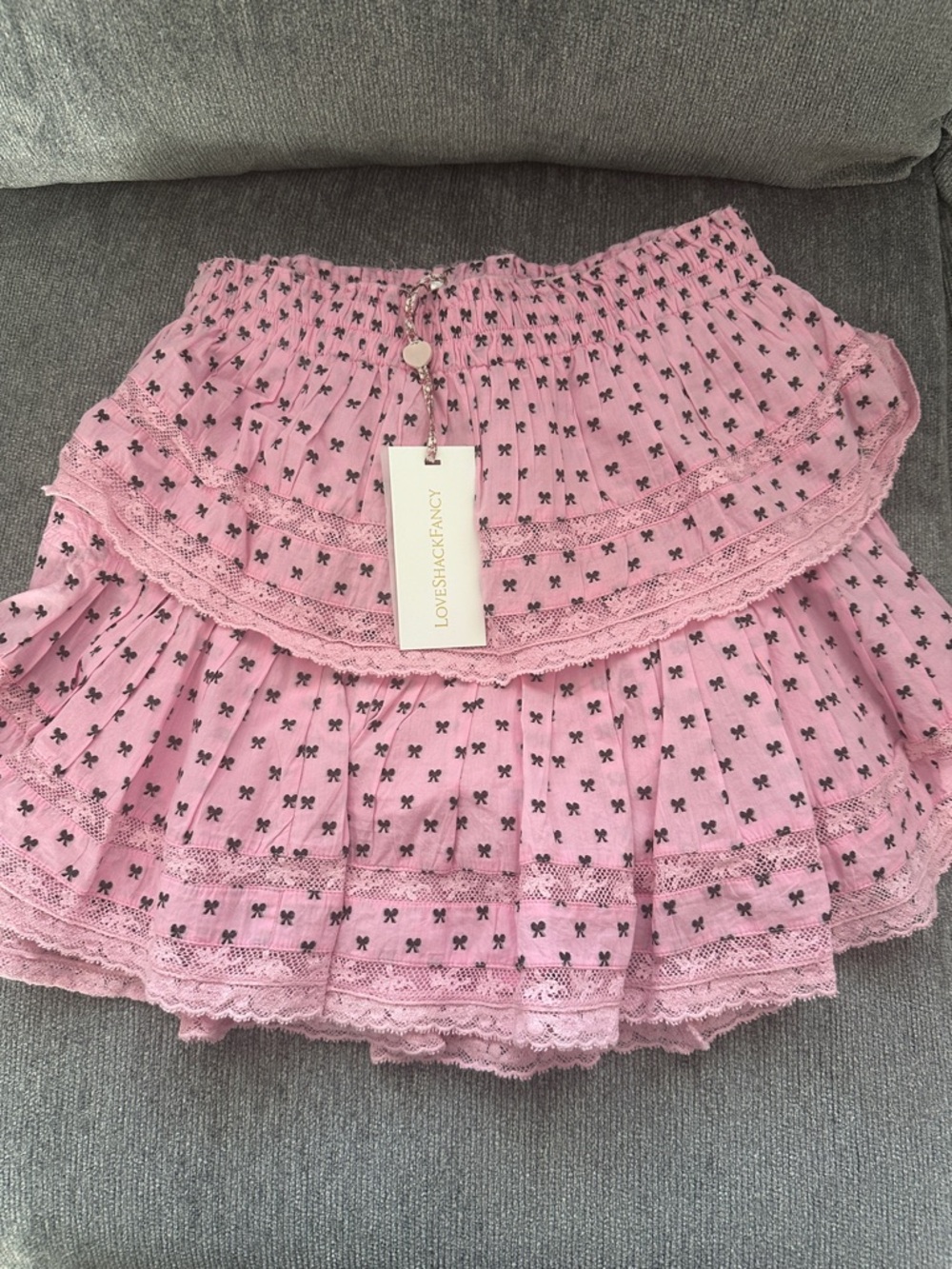 LoveShackFancy Classic Pink Tiered Lace Ruffle Mini Skirt with Black Bow Print